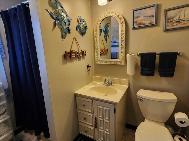 full bathroom featuring toilet and vanity