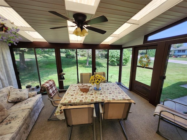 sunroom with ceiling fan and lofted ceiling