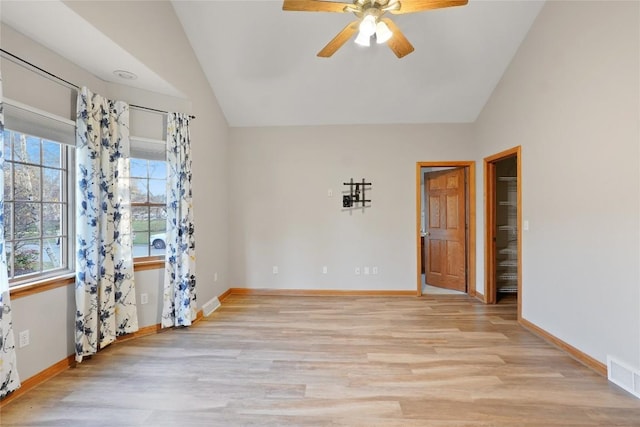 spare room featuring light wood-type flooring, ceiling fan, and lofted ceiling