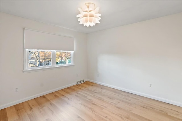 spare room featuring light hardwood / wood-style flooring