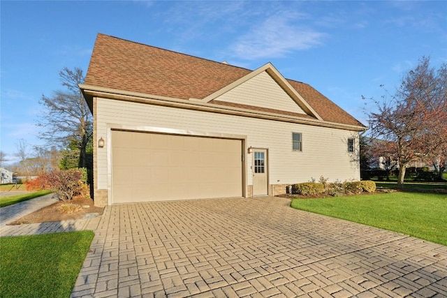 view of property exterior featuring a lawn and a garage