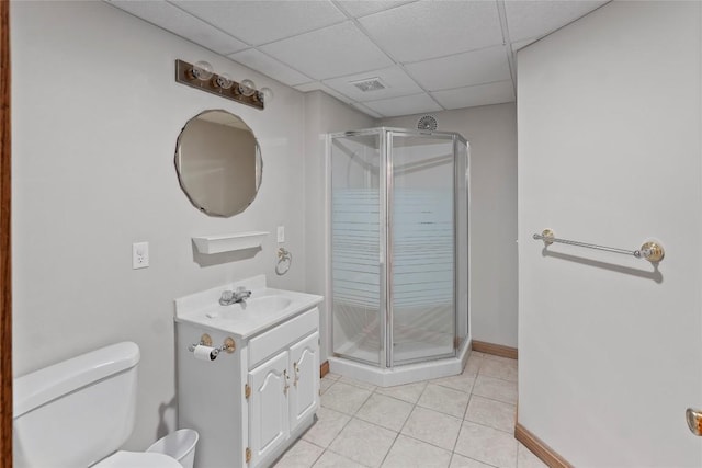 bathroom featuring vanity, a drop ceiling, tile patterned flooring, toilet, and an enclosed shower