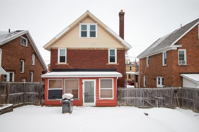 view of snow covered back of property