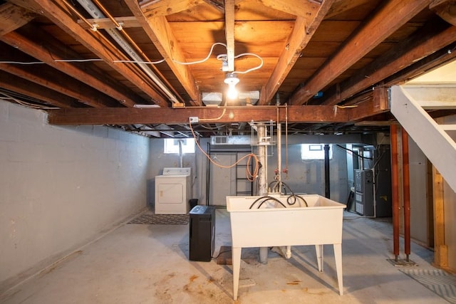 basement with washer / clothes dryer, sink, and heating unit