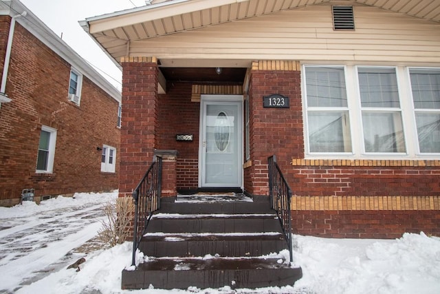 view of snow covered property entrance