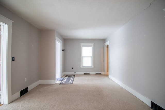 unfurnished room with light colored carpet