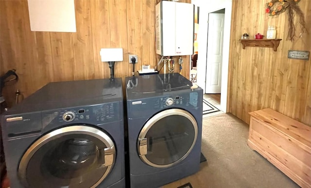 11694 Oakfield Rd, Conneaut Lake, PA 16316 - washroom with washing machine and dryer, tankless water heater, wood walls, and carpet flooring