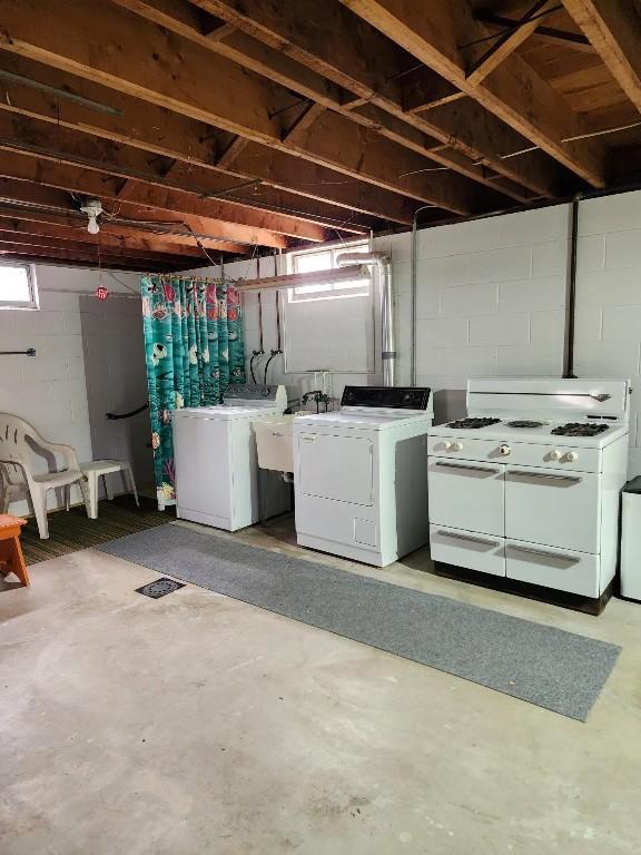 basement featuring washing machine and dryer and a sink