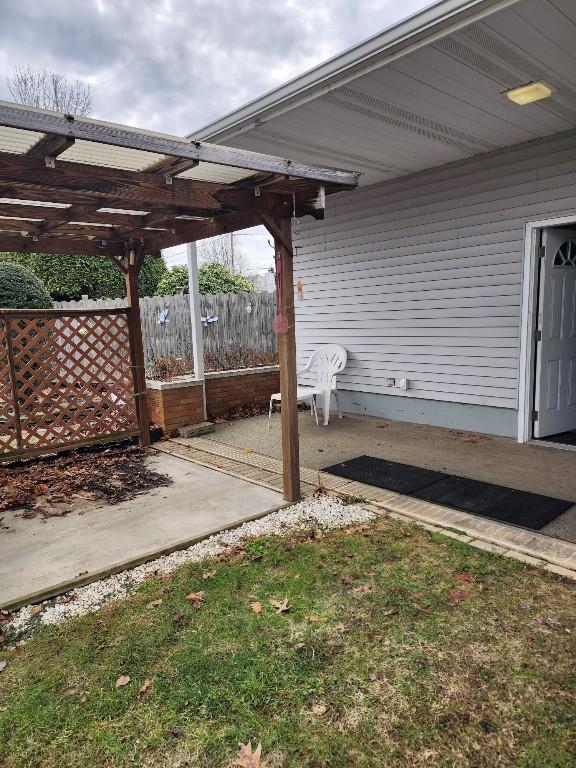 view of patio / terrace featuring fence