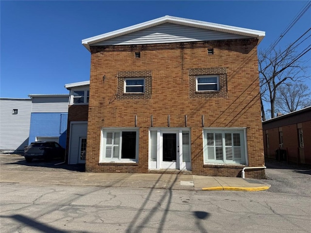 back of house featuring brick siding