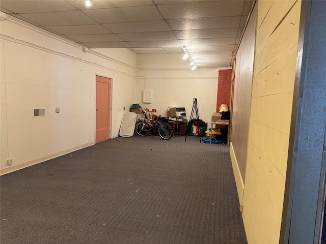 basement featuring carpet floors and a drop ceiling