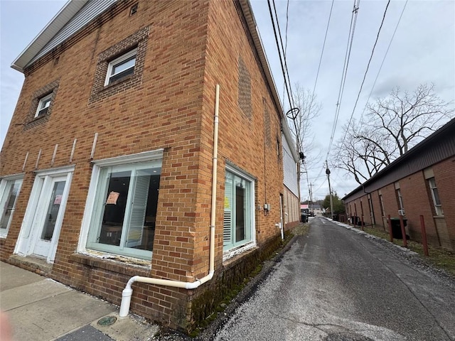 view of side of property with brick siding