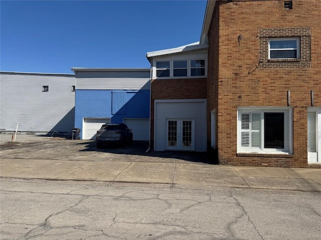 exterior space featuring french doors and brick siding