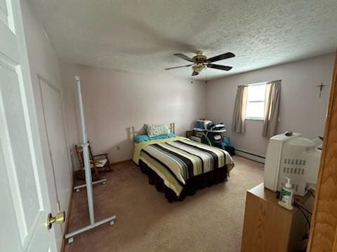 bedroom with ceiling fan, baseboard heating, and a textured ceiling