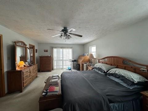 bedroom featuring ceiling fan, light carpet, and a textured ceiling