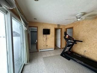 workout area with ceiling fan and baseboard heating