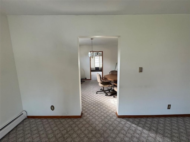 unfurnished room with an inviting chandelier, carpet floors, and a baseboard heating unit