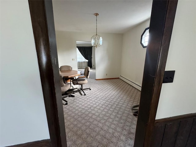 carpeted home office featuring a baseboard radiator, a wealth of natural light, and an inviting chandelier