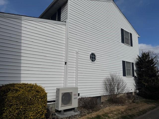 view of side of property featuring ac unit