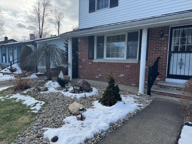 view of snow covered property entrance