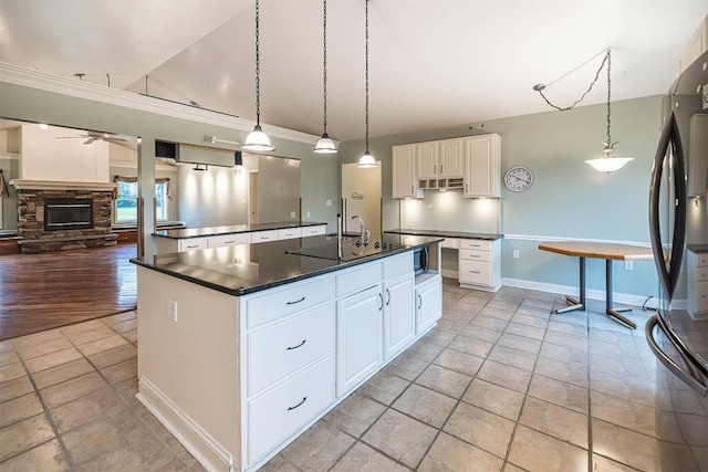 8730 Peffer Rd, Fairview, PA 16415 - kitchen featuring refrigerator, dark countertops, a ceiling fan, lofted ceiling, and a center island with sink