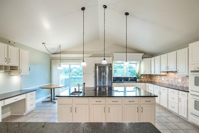 8730 Peffer Rd, Fairview, PA 16415 - kitchen featuring freestanding refrigerator, vaulted ceiling, backsplash, healthy amount of natural light, and a sink