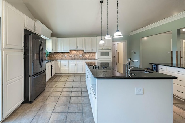 8730 Peffer Rd, Fairview, PA 16415 - kitchen with freestanding refrigerator, a sink, ornamental molding, a center island with sink, and backsplash