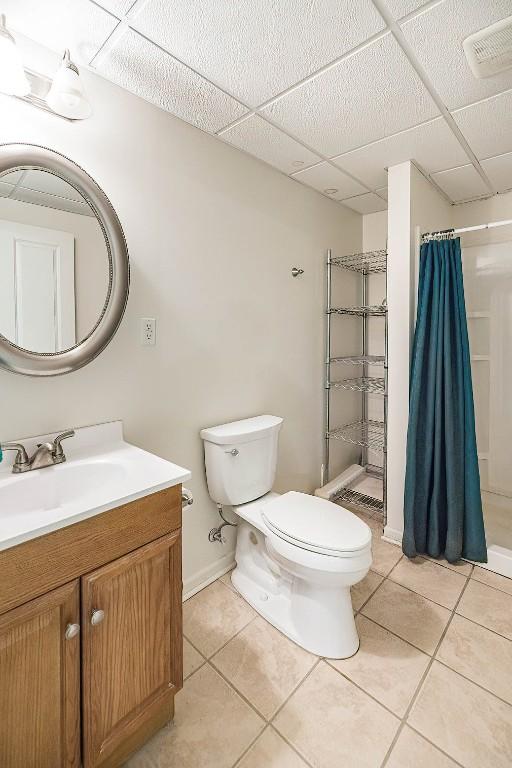 8730 Peffer Rd, Fairview, PA 16415 - bathroom with toilet, tile patterned flooring, a shower with shower curtain, vanity, and a drop ceiling