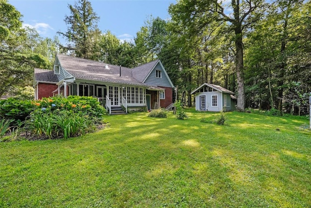 6750 W Ridge Rd, Fairview, PA 16415 - back of house with a yard, an outdoor structure, a shingled roof, and french doors