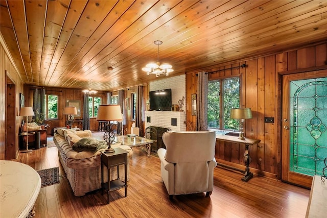 6750 W Ridge Rd, Fairview, PA 16415 - living area featuring healthy amount of natural light, wood ceiling, a chandelier, wooden walls, and wood finished floors