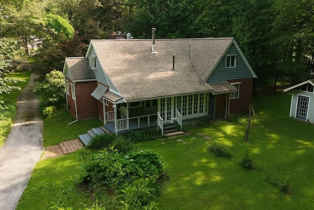 6750 W Ridge Rd, Fairview, PA 16415 - view of front of house featuring covered porch, a front lawn, and roof with shingles