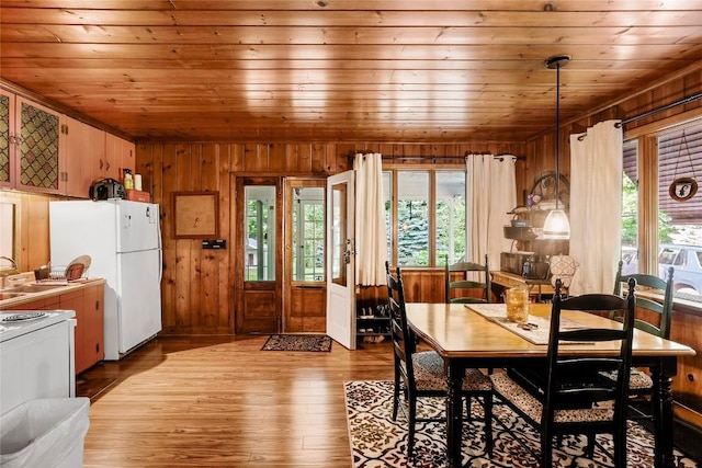 6750 W Ridge Rd, Fairview, PA 16415 - dining room featuring wood ceiling, wooden walls, healthy amount of natural light, and light wood-style flooring