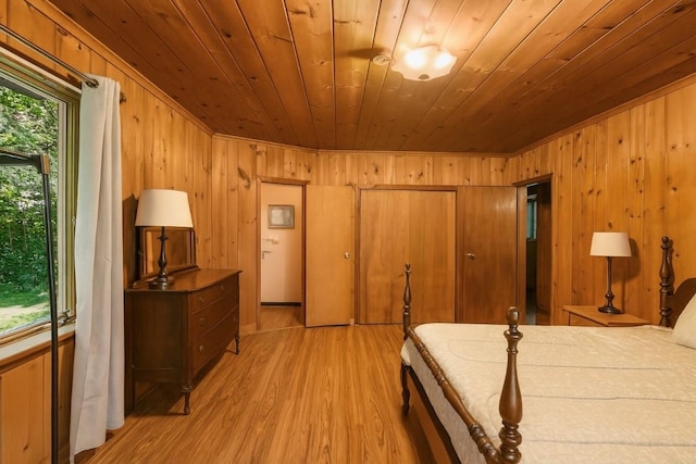6750 W Ridge Rd, Fairview, PA 16415 - bedroom with wooden ceiling, wooden walls, and light wood-type flooring