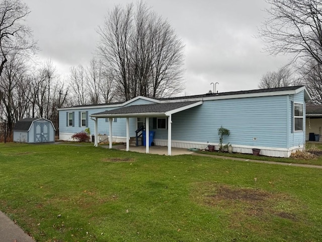 back of property featuring a storage unit, a patio area, and a lawn