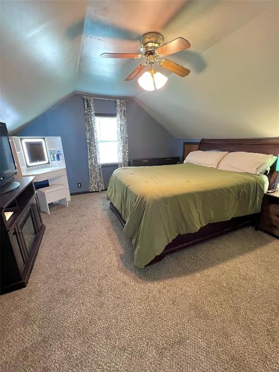 bedroom featuring ceiling fan, carpet, and vaulted ceiling