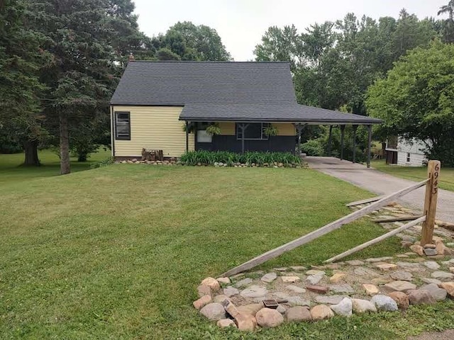 6943 Old Ridge Rd, Fairview, PA 16415 - view of front of home with a carport, concrete driveway, a front yard, and a shingled roof