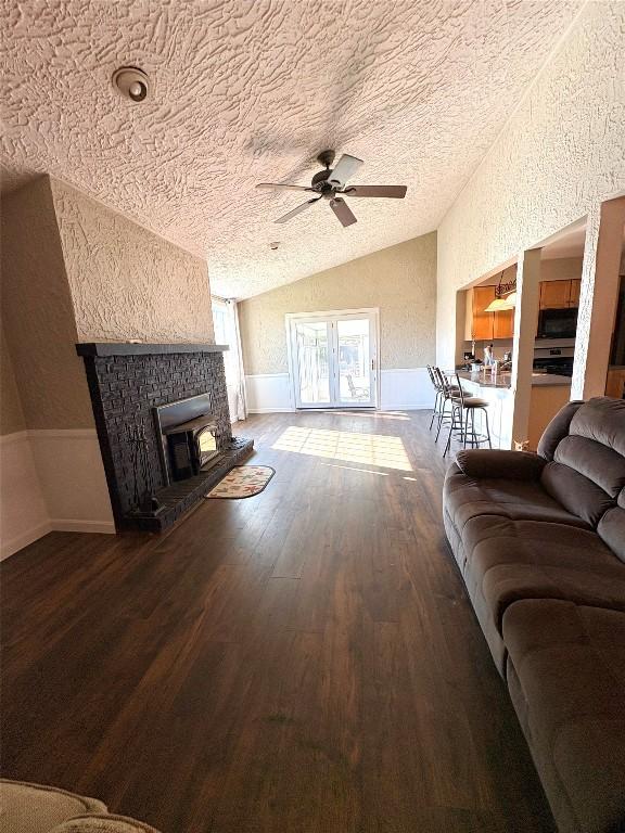 4224 Amherst Rd, Millcreek, PA 16506 - living area with vaulted ceiling, a textured ceiling, wood finished floors, a ceiling fan, and wainscoting
