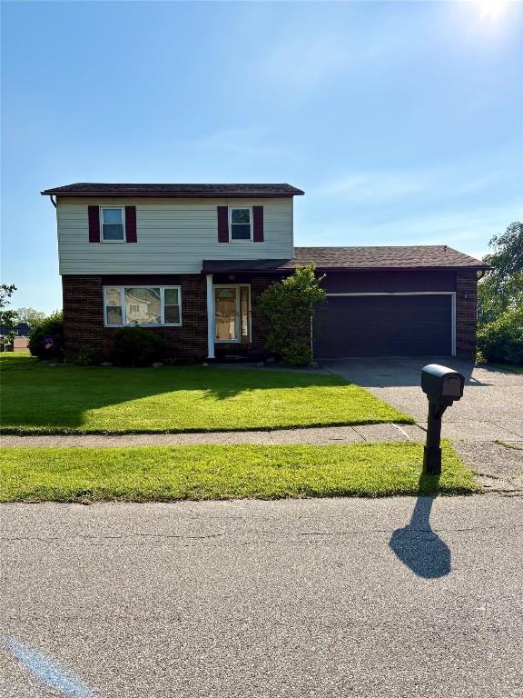 4224 Amherst Rd, Millcreek, PA 16506 - view of front facade featuring an attached garage, a front lawn, and driveway