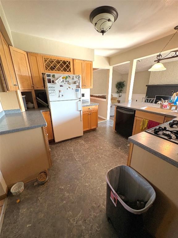4224 Amherst Rd, Millcreek, PA 16506 - kitchen with black dishwasher, freestanding refrigerator, gas cooktop, and light brown cabinetry