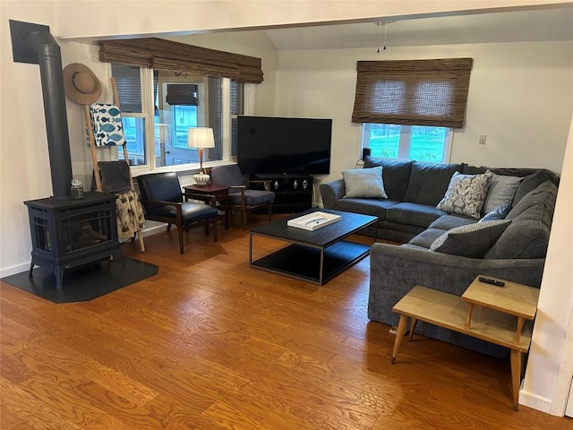 living room with hardwood / wood-style floors and a wood stove