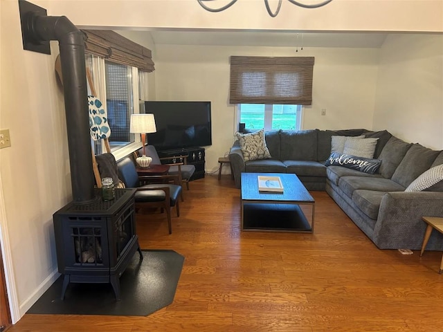 living room with wood-type flooring and a wood stove