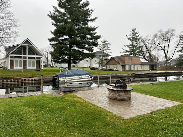 exterior space featuring a water view, a patio, and an outdoor fire pit