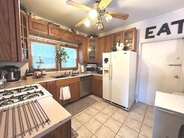 kitchen with sink, ceiling fan, light tile patterned floors, and appliances with stainless steel finishes