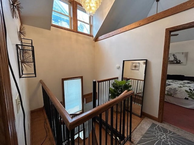 stairway with high vaulted ceiling, a chandelier, and carpet flooring