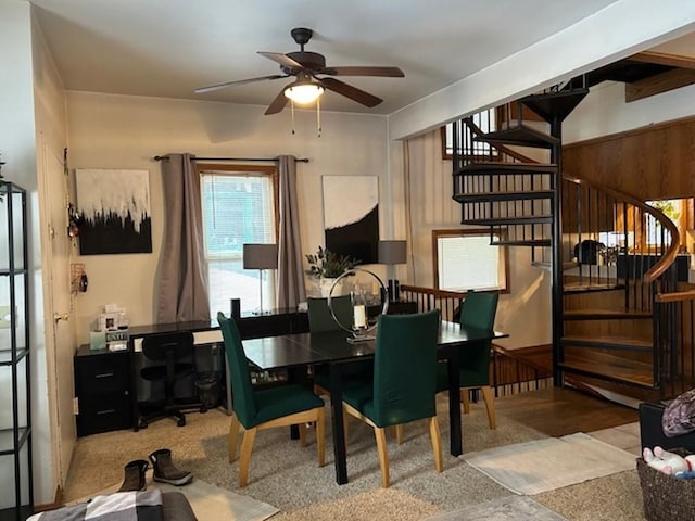 carpeted dining area with ceiling fan