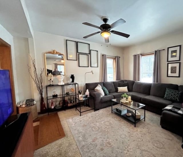 carpeted living room with ceiling fan