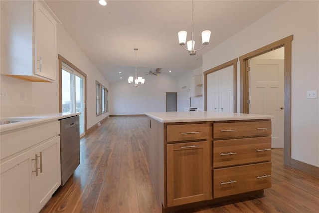 kitchen featuring dishwasher, white cabinets, a kitchen island, and hanging light fixtures