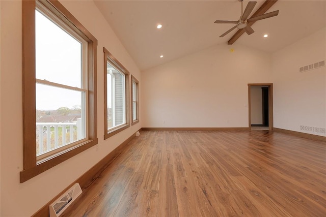 unfurnished room with beamed ceiling, ceiling fan, light hardwood / wood-style floors, and high vaulted ceiling