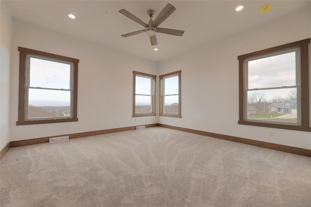 carpeted empty room with ceiling fan