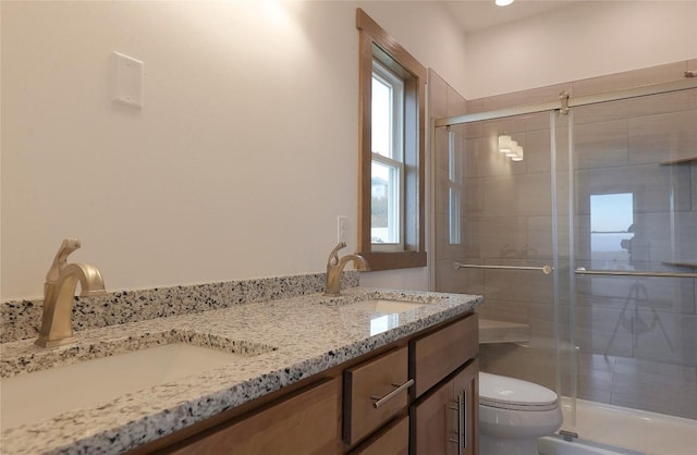 bathroom featuring vanity, toilet, and walk in shower